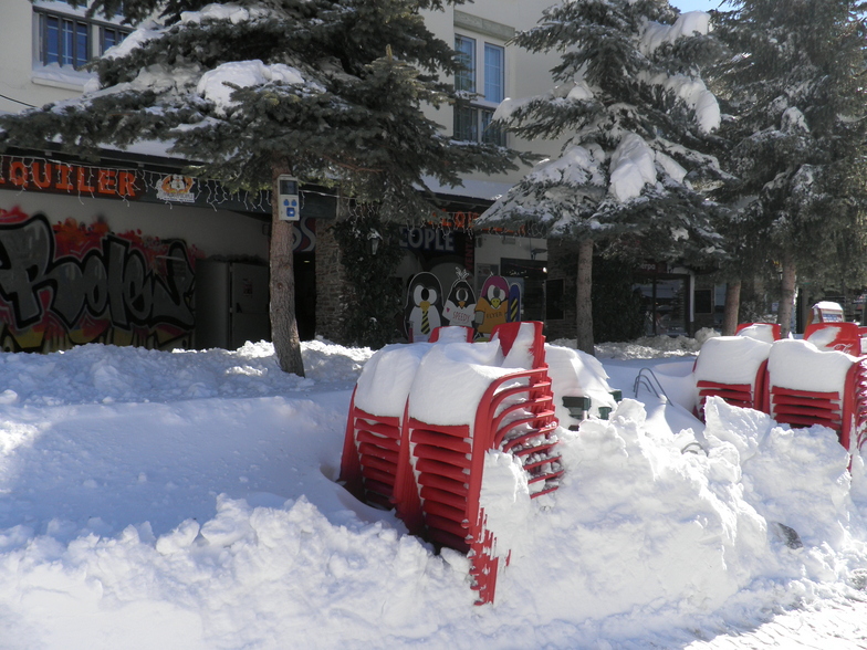 Snow on stacked up red chairs, Sierra Nevada